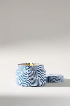 two blue and white bowls sitting next to each other on top of a white surface