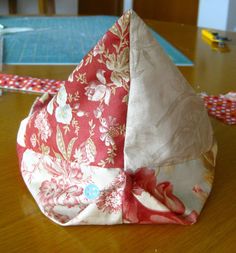 an origami hat sitting on top of a wooden table