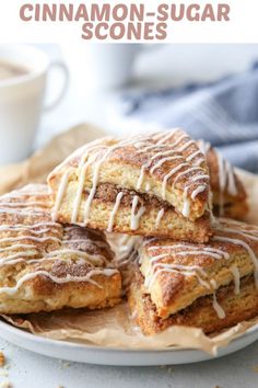 cinnamon sugar scones are stacked on top of each other with icing drizzle