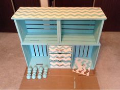 a doll house made out of cardboard with blue and white chevrons on it