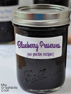 there is a jar of blueberry preserves on the table