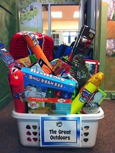 the great outdoorss basket is full of toys and books for children to play with