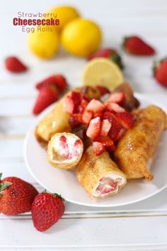 some food is on a white plate with strawberries and lemons