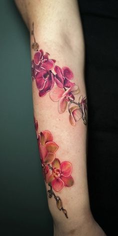 a woman's arm with pink flowers on it