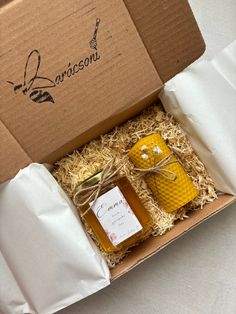 two jars of honey in a cardboard box