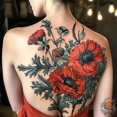 the back of a woman's body with red flowers on her shoulder and chest