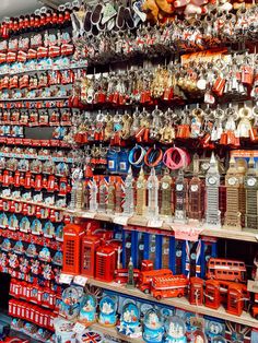 many different types of clocks on display in a store with red, white and blue colors