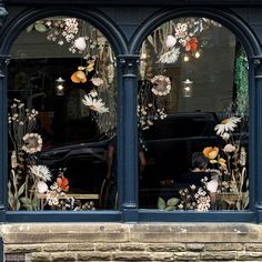 an image of a store window decorated with flowers