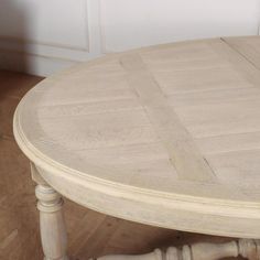 a white wooden table sitting on top of a hard wood floor