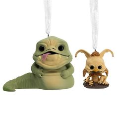 an ornament shaped like a creature and another animal hanging from it's back