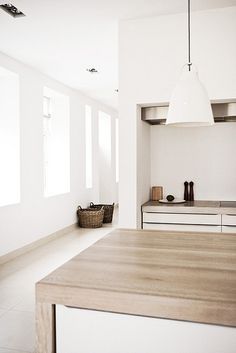 a blurry image of a kitchen counter top and cabinets in a room with white walls