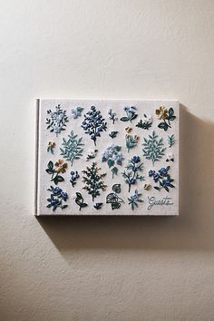 a white wall with blue and green flowers on it