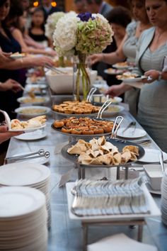 a long table filled with lots of food and plates on top of it's sides