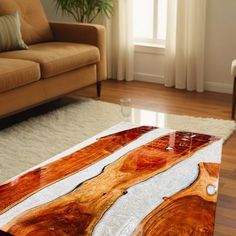 a coffee table made out of wood on top of a rug in front of a couch