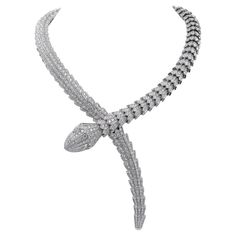 In a tribute to its spirit animal, Bulgari captures the power of seduction in this Serpenti Diamond High Jewelry necklace, camouflaging sensuality and temptation with a hypnotic design. Sophisticated and glamorous, this jewel coils around the neck striking with the precious beauty of the scales and with the distinctive sinuosity of the snake. At its heart, this opulent necklace features a breathtaking arrangement of approximately 75.50 carats of diamond pavé, meticulously hand-set to reflect a s Serpent Necklace Bulgari, Snake Diamond Necklace, Bulgari Snake Necklace, Bvlgari Necklace Snake, Bvlgari Jewelry Set, Diamond High Jewelry, High Jewelry Necklace, Power Of Seduction, Bulgari Necklace