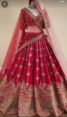 a red and gold bridal gown on display