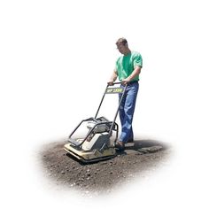 a man is using a lawn mower on the ground