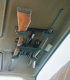 the interior of a vehicle with various items hanging from it's ceiling, including two cups and spoons