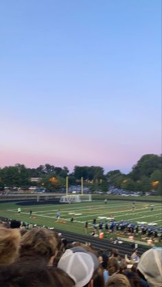 a large group of people watching a football game