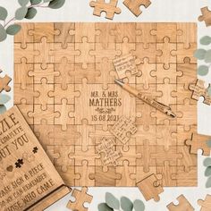 personalized wooden puzzles with names and date engraved on the side, surrounded by leaves