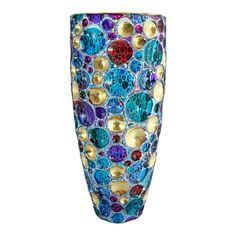 a colorful vase with lots of different colored dots on the bottom and gold rims