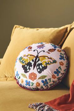 a butterfly pillow sitting on top of a bed