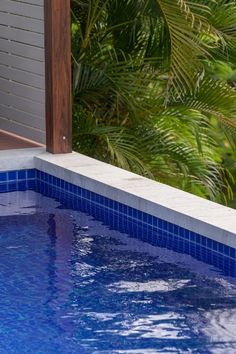 A pool fully tiled in blue mosaics by The Pool Tile Company Blue Pool, Pool Coping, Stone Cladding, Blue Mosaic