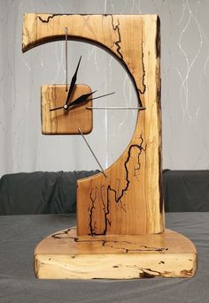 a clock made out of wood sitting on top of a table