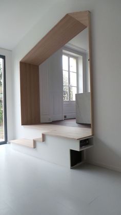 an empty room with white walls and wooden steps