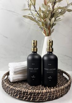 two black bottles sitting on top of a wicker tray