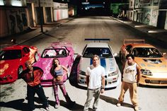 three men and two women standing in front of four different colored sports cars with the words fast & furios on it