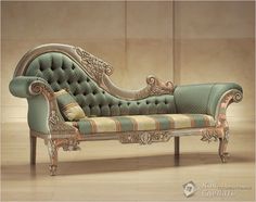 an ornately decorated couch sitting on top of a hard wood floor next to a wall