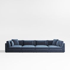 a blue couch sitting on top of a white floor