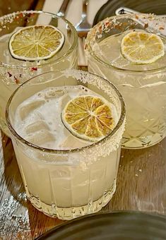 two glasses filled with ice and lemon slices