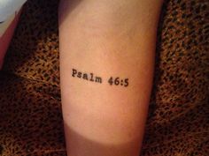 a person with a small tattoo on their arm that says,'psalm 465 '