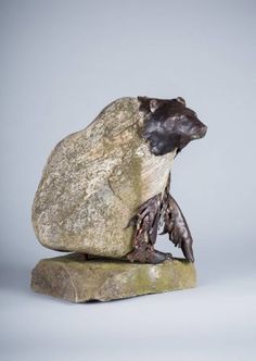 a sculpture of a bear on top of a rock