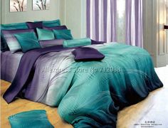 the bed is made with purple and teal colored comforter sets on top of it