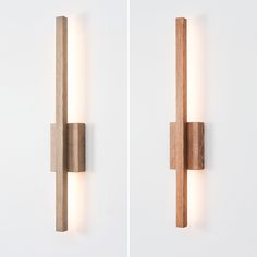 two wooden sconces mounted to the side of a wall next to each other