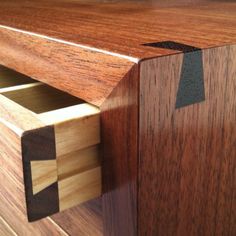 a close up of a wooden drawer with drawers on each side and an arrow in the middle