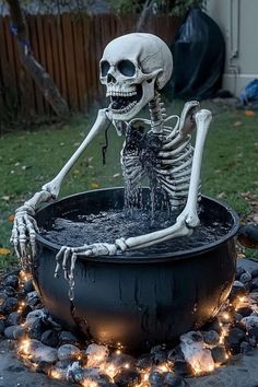 a skeleton sitting in a pot full of water and spewing it's head