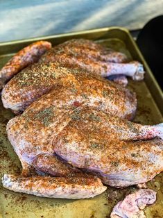 some meat is sitting on a pan with seasoning