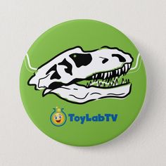 a green button with a dinosaur's head and the word toylab tv on it