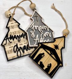 three wooden christmas ornaments hanging from strings