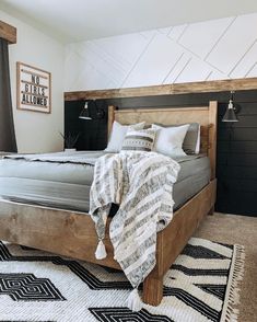 a bed sitting in the middle of a bedroom next to a black and white rug