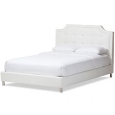 a white bed with an upholstered headboard and foot board on the side