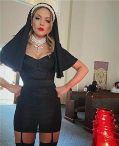 a woman dressed in black posing for the camera