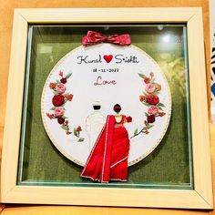 a cross stitch picture with a bride and groom holding hands