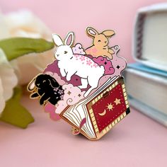 a close up of a pin on a pink surface with flowers in the foreground