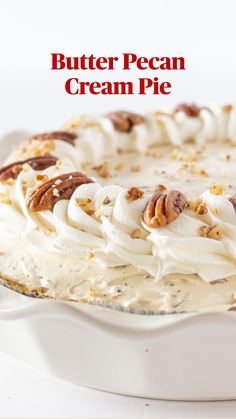 a cake with white frosting and pecans on top is in a pie pan