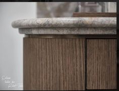 a marble top on a wooden cabinet in a room